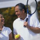 Smiling Couple on Tennis Court