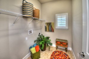 This closet at the Vienna model home in Plantation Bay has baskets and a stool - ready to make the most of the closet storage space.